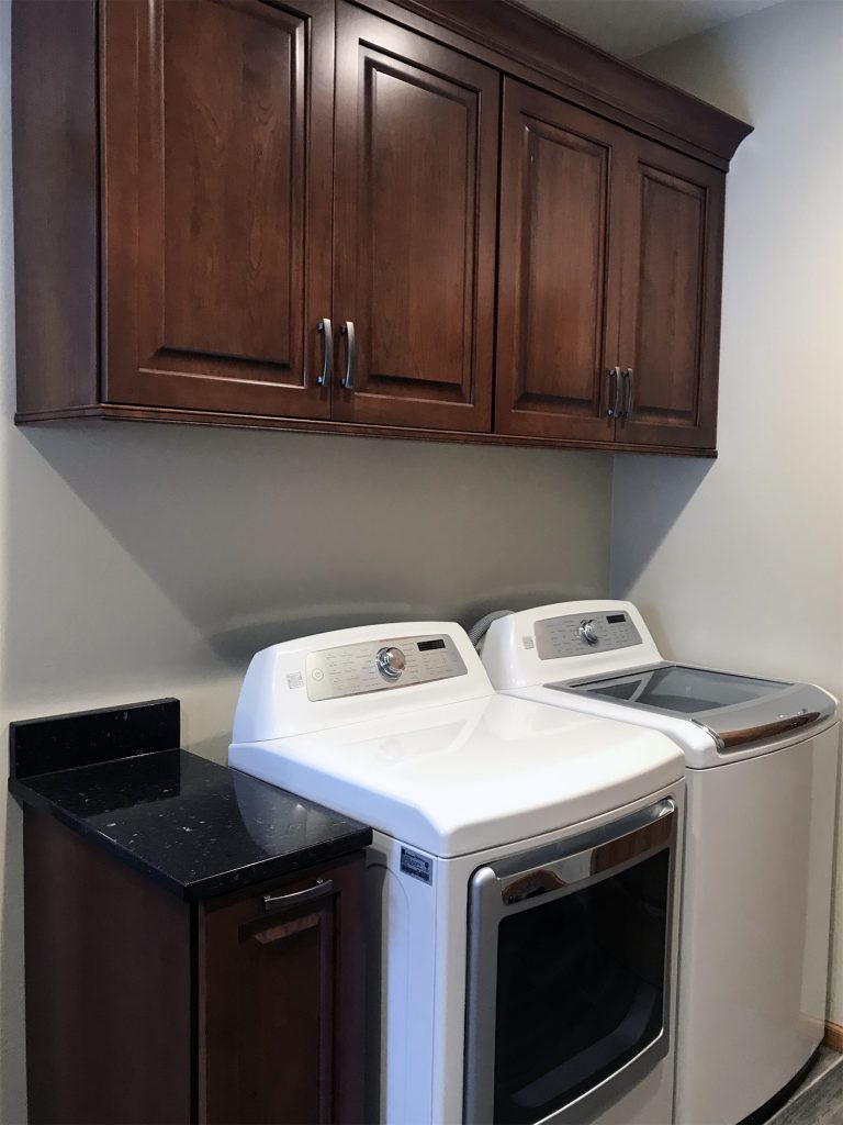 Laundry room with dark cabinets