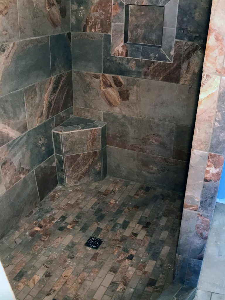 Dark stone tile shower surround