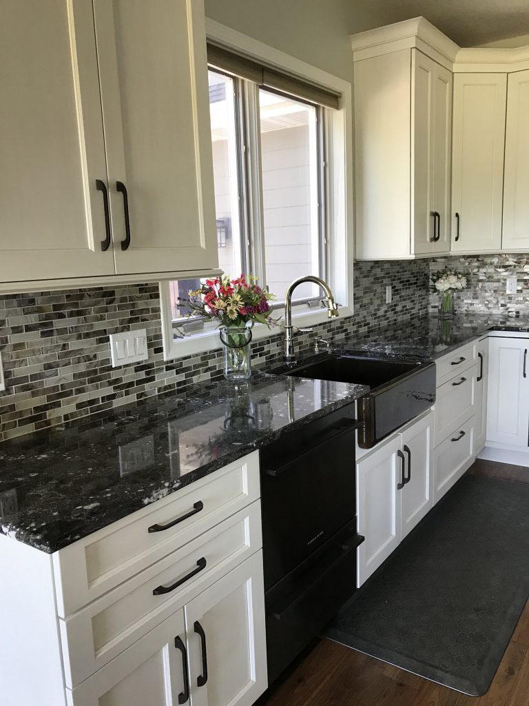 White kitchen cabinets with dark farmhouse sink