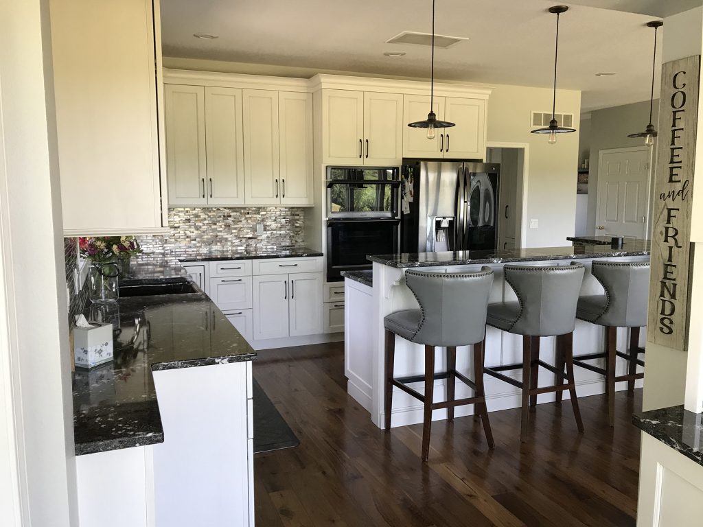White kitchen with glass tiled backsplash