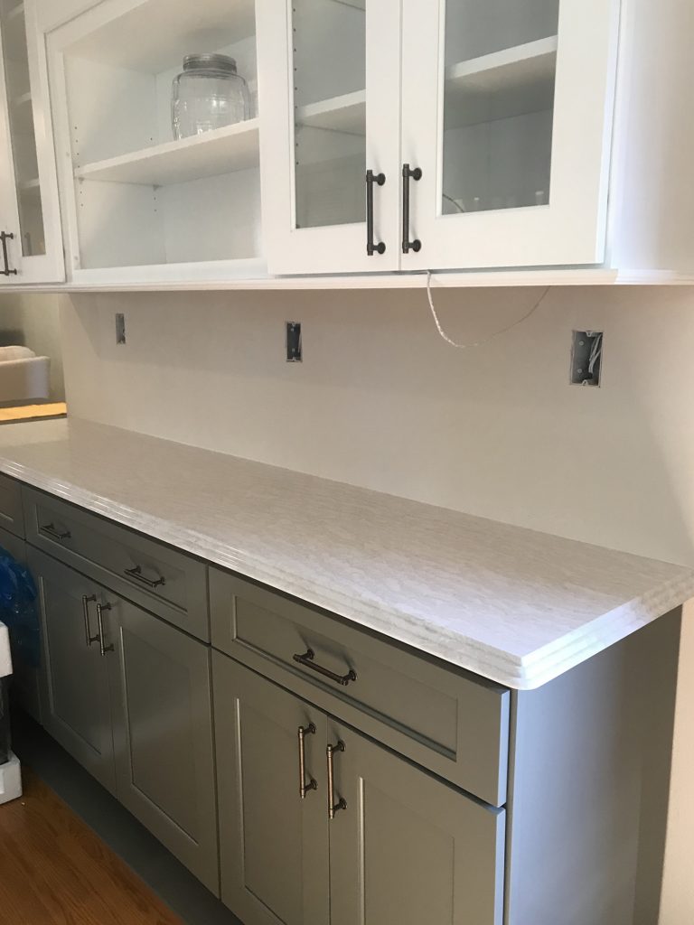 White upper cabinets, dark gray lower cabinets