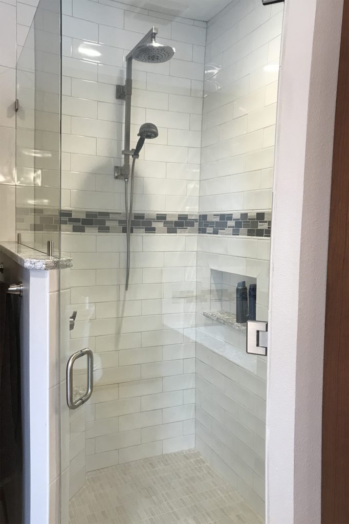 White subway tile shower with glass enclosure