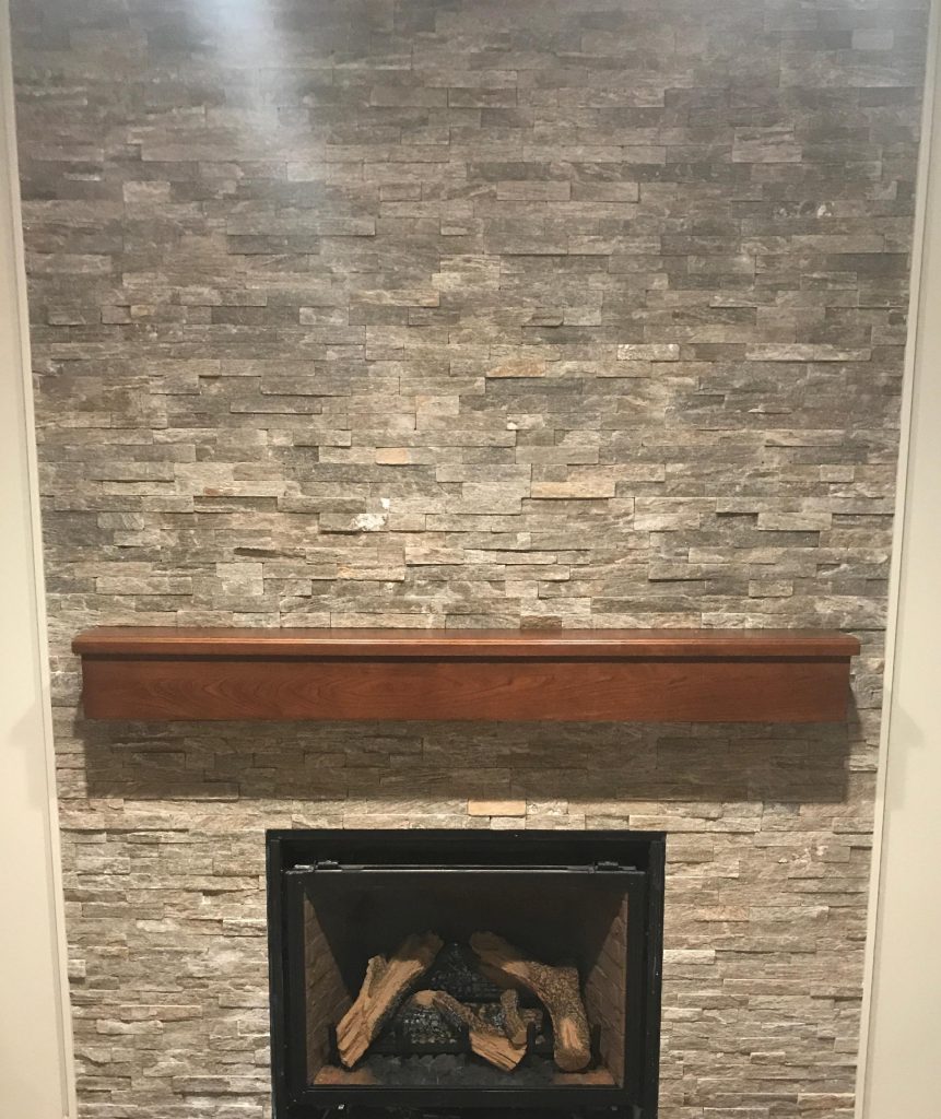 Fireplace after stacked stone, dark mantle